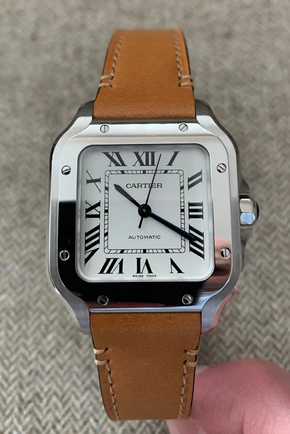 Cartier Santos de Cartier medium model watch with a steel case, silvered opaline dial, and a brown calfskin strap..